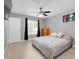 Bright bedroom featuring a ceiling fan, neutral decor, and a view to the ensuite bathroom at 4068 Palau Dr, Sarasota, FL 34241