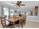 Bright dining room features a wooden table, seating for eight, and blends seamlessly into the kitchen at 4068 Palau Dr, Sarasota, FL 34241