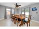 Bright dining room with large table, ceiling fan, natural light, neutral walls, and tile floors at 4068 Palau Dr, Sarasota, FL 34241