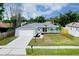 Single-Gathering home featuring a well-kept lawn, front garden, and an attached garage at 4068 Palau Dr, Sarasota, FL 34241