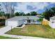 Charming single-story home with a well-maintained lawn, tidy landscaping, and attached garage at 4068 Palau Dr, Sarasota, FL 34241
