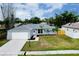 Well-maintained single Gathering home with manicured lawn, mature landscaping, and a two-car garage at 4068 Palau Dr, Sarasota, FL 34241