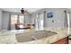 Modern kitchen with granite countertops, stainless steel appliances, with open layout to the dining room at 4068 Palau Dr, Sarasota, FL 34241