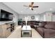 Comfortable living room with tile floors, a ceiling fan, and a sectional sofa at 4068 Palau Dr, Sarasota, FL 34241