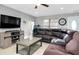 Cozy living room featuring tile floors, a large sectional sofa, and neutral wall colors at 4068 Palau Dr, Sarasota, FL 34241