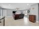 Open living room with tile flooring, ceiling fan and recessed lighting with furniture, TV, and view to kitchen at 4068 Palau Dr, Sarasota, FL 34241