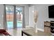 Bright living room with tile flooring, sliding glass doors leading to a screened pool and neutral gray colored walls at 4068 Palau Dr, Sarasota, FL 34241