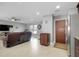 Open living room with tile flooring, ceiling fan and recessed lighting with furniture, TV, and view to kitchen at 4068 Palau Dr, Sarasota, FL 34241