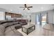 Open-concept living room with tile floors, leading into a kitchen with dark wood cabinets at 4068 Palau Dr, Sarasota, FL 34241