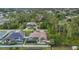 Aerial view of a home nestled among lush greenery, featuring a screened pool and backyard at 4305 Sandune Ave, North Port, FL 34287