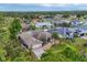 Aerial view of the house highlighting lush landscaping and private pool, surrounded by mature trees at 4305 Sandune Ave, North Port, FL 34287