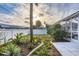 Serene backyard featuring lush landscaping, palm trees, and privacy fence at 4305 Sandune Ave, North Port, FL 34287
