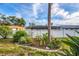 Landscaped backyard with tropical plants, a privacy fence, and blue skies overhead at 4305 Sandune Ave, North Port, FL 34287
