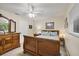 Comfortable bedroom with a wooden bed frame, ceiling fan, and natural light at 4305 Sandune Ave, North Port, FL 34287