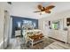 Well-lit main bedroom featuring an accent wall, light wood floors and outdoor views at 4305 Sandune Ave, North Port, FL 34287