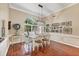 Dining area features hardwood floors, a modern light fixture, and beautiful wainscoting details at 4305 Sandune Ave, North Port, FL 34287