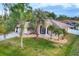 Beautiful single-story home with lush landscaping, palm trees, and well-maintained lawn at 4305 Sandune Ave, North Port, FL 34287