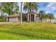 Charming single-Gathering home with a well-manicured lawn and palm trees in a sunny environment at 4305 Sandune Ave, North Port, FL 34287