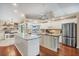 Bright kitchen featuring a large island, granite countertops, stainless steel refrigerator, and modern cabinetry at 4305 Sandune Ave, North Port, FL 34287