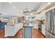 Bright kitchen boasts wood floors, stainless appliances, white cabinets, and center island at 4305 Sandune Ave, North Port, FL 34287