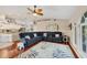 Spacious living room with a large sectional sofa, accent rug, and adjacent kitchen area at 4305 Sandune Ave, North Port, FL 34287