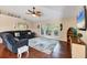 Inviting living room with vaulted ceilings, a ceiling fan, and large windows offering natural light at 4305 Sandune Ave, North Port, FL 34287