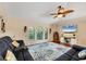 Bright living room featuring vaulted ceilings, a ceiling fan, and a large area rug at 4305 Sandune Ave, North Port, FL 34287