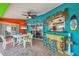 Vibrant outdoor patio featuring a tiki bar, dining set, and colorful decor at 4305 Sandune Ave, North Port, FL 34287