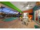 Inviting pool area with outdoor seating and colorful, modern decor and lights at 4305 Sandune Ave, North Port, FL 34287