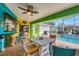 Outdoor pool patio area boasts a bar, table and chairs, and stylish colorful decorations at 4305 Sandune Ave, North Port, FL 34287