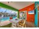 Outdoor pool patio boasts a table and chairs, a mounted tv, and stylish decorations at 4305 Sandune Ave, North Port, FL 34287