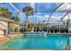 View of the pool area featuring a fountain and palm trees at 4305 Sandune Ave, North Port, FL 34287