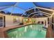 Covered pool with outdoor seating, greenery, and modern, open-concept design at 4305 Sandune Ave, North Port, FL 34287