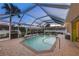 Enclosed pool with backyard foliage and lighting, complemented by outdoor seating at 4305 Sandune Ave, North Port, FL 34287