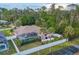 Features a screened lanai, pool, spacious yard with white vinyl fencing, and lush landscaping, perfect for outdoor enjoyment at 4305 Sandune Ave, North Port, FL 34287