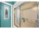 Bathroom featuring a walk-in shower with a sliding glass door and a decorative door at 4305 Sandune Ave, North Port, FL 34287