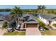Beautiful home backing up to a pond with a brick paved driveway and lush tropical landscaping at 4835 San Ortebello Dr, Bradenton, FL 34208
