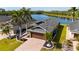 Back aerial view of a charming home backing up to a large pond with a luscious green yard at 4835 San Ortebello Dr, Bradenton, FL 34208