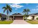Charming single Gathering home featuring a brick paved driveway and lush tropical landscaping at 4835 San Ortebello Dr, Bradenton, FL 34208