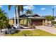 Beautiful home featuring a brick paved driveway, tropical landscaping, and a brown two-car garage door at 4835 San Ortebello Dr, Bradenton, FL 34208