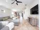 Bright living room boasting tile flooring, neutral paint, a gray sectional sofa, and an entertainment center at 4835 San Ortebello Dr, Bradenton, FL 34208