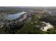 Aerial view of a neighborhood bordering a lake, showcasing the community's layout and natural surroundings at 4907 Wedgeleaf Way, Palmetto, FL 34221