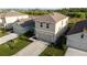An aerial view displays a two-story home with a well-kept lawn and driveway leading to a two-car garage at 4907 Wedgeleaf Way, Palmetto, FL 34221
