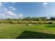 Backyard featuring a stone firepit and a view of wild growth at 4907 Wedgeleaf Way, Palmetto, FL 34221