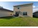 The backyard features a manicured lawn, patio area, and space for outdoor activities at 4907 Wedgeleaf Way, Palmetto, FL 34221