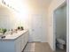 Well-lit bathroom featuring double sinks, and access to a separate toilet area for added privacy at 4907 Wedgeleaf Way, Palmetto, FL 34221