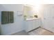 Bright bathroom with a double vanity, ample counter space, and a decorative rug at 4907 Wedgeleaf Way, Palmetto, FL 34221