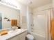 Well-lit bathroom featuring a bathtub-shower combination and white tile at 4907 Wedgeleaf Way, Palmetto, FL 34221