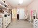 Spacious bedroom with pink walls, a hanging hammock chair, and an elegant dresser at 4907 Wedgeleaf Way, Palmetto, FL 34221