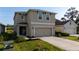 Two-story home with a neutral color palette, landscaping, and a driveway leading to the two-car garage at 4907 Wedgeleaf Way, Palmetto, FL 34221